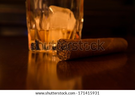 whiskey and cigar on desk