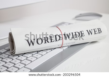 world wide web written on newspaper on keyboard