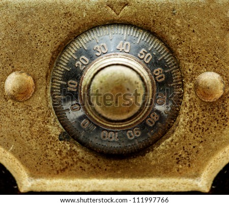 Early 1900s dial combination lock close up. Black dail and gold plate.