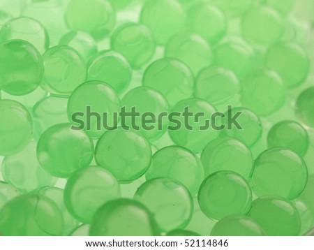 Green polymer gel spheres close up, with depth of view