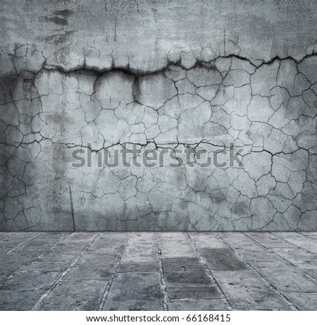 Grungy distressed stone wall and floor with large cracks.