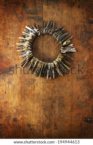 Many old keys on a well used old wooden surface. Security and encryption, concept image.