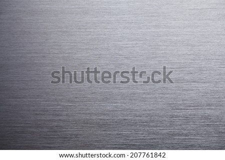 Brushed metal texture, shadow on lower left.