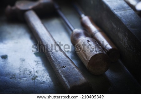 Handles of  old hand tools, Hammer and screw driver and an awl.