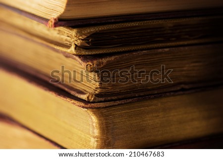 Very old books in light and shadow. Shallow depth of field.
