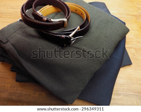 Mens trousers and belt on table ready for use.