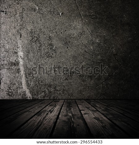 Dark room with stone wall and grungy old wooden floor.