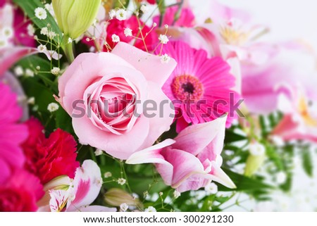 Pinkish tone flower bouquet, with focus on light pink rose. shallow depth of field. high key.