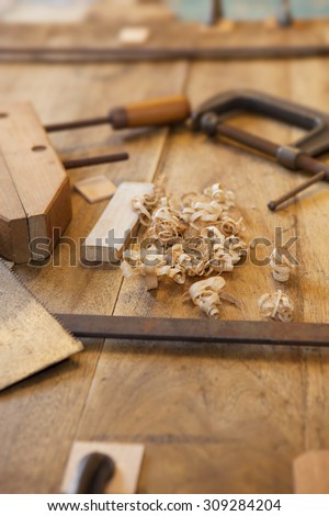 Wood working or a carpentry. Clamps and wood shavings on a work piece.