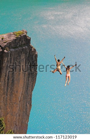 two cliff jumping girls, against turquoise ocean