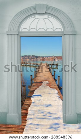 view through arched door,wintry boardwalk at the lake