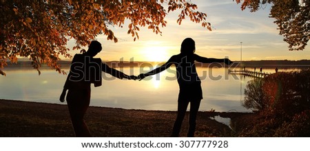 girl friends at the lake shore - summer evening at lake starnberg, bavaria