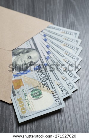 Open recycle paper envelope with hundreds banknotes inside