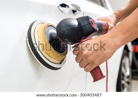 Car polishing series : Worker waxing white car