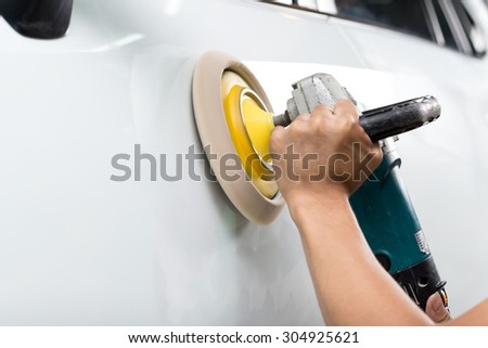 Car polishing series : Worker waxing white car door