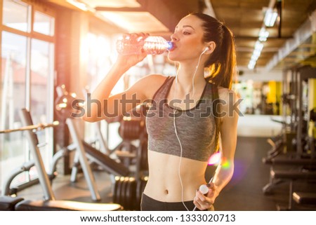 Image, Stock Photo Slim sportswoman drinking water in park