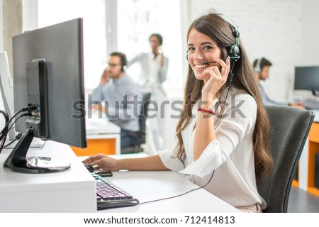 Young friendly operator woman agent with headsets working in a call centre. Stock foto © 