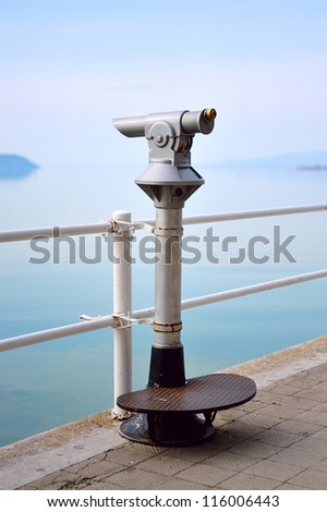 Old touristic telescope by the lakeside