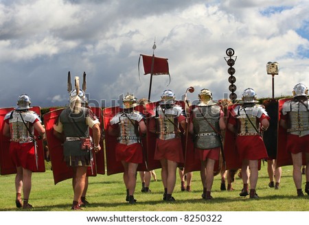 Roman Legion Marches on to War with swords drawn under Stormy Skies in Northumberland, England
