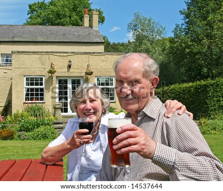 Cheers to over fifty years of married life. Couple in their 80s raise their glasses