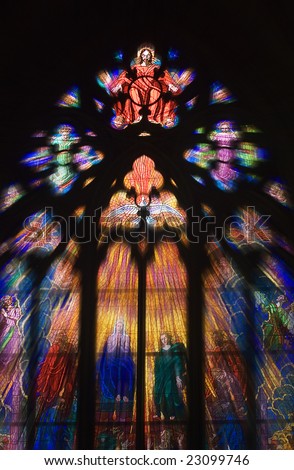Seeing the light and peace concept with light shafts coming through stunning stain glass Church Window as Christ holds out his hands with a Dove underneath