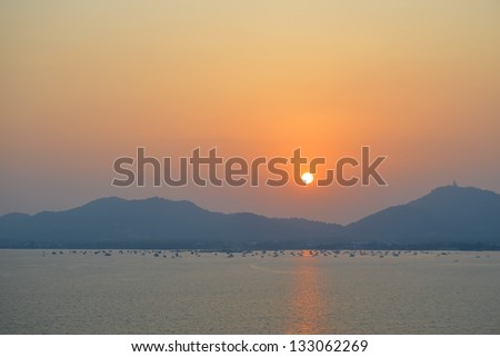 sunset over sea and mountain, Yachts in twilight phuket Thailand