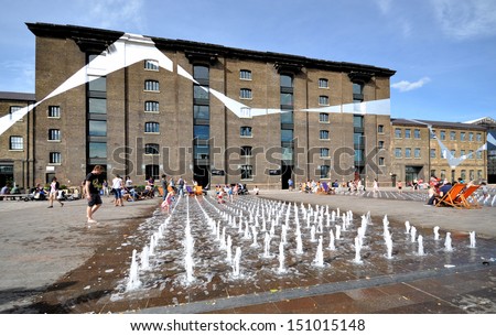 LONDON - AUGUST 4. Granary Square is a new regeneration development with over 1000 small programmed fountains and geometric graphics coordinating the historic buildings; August 4, 2013 in London, UK