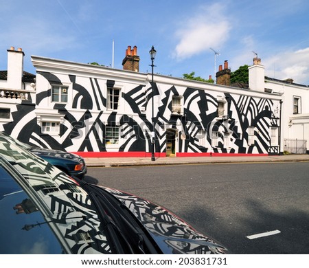 LONDON - JULY 1. The facade of Chelsea Arts Club on July 1, 2014; a temporary tribute to the World War One British and USA artists who painted ships in Dazzle Camouflage, located in Chelsea, London.