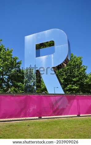 LONDON - JULY 3. One of Monica Bonvicini's 29.5 feet (9 metre) reflective  letters from her RUN installation on July 3, 2014 by the Copper Box Arena in the Queen Elizabeth Olympic Park, London.