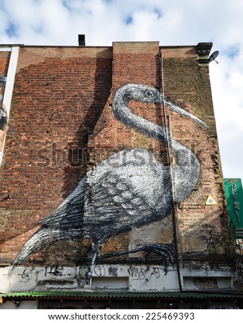 LONDON - OCOBER 11. A huge painting of a Crane by Belgian artist Roa on an old brick wall at a popular street art derelick bomb site in Hanbury Street on October 11, 2014 in east London, UK.