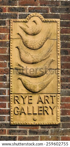RYE, SUSSEX, UK - MARCH 7, 2015. An external carved sign at the Rye Art Gallery. The listed herigage buildings house works by 19th and 20th century artists, in the town of Rye, Sussex, England, UK.
