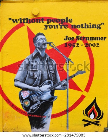 LONDON - MARCH 14. 2015. Street art remembrance painting by Emma Harrison and Gary Loveridge of Joe Strummer, punk rock guitarist, songwriter and lead vocalist of Clash, in west London, UK.