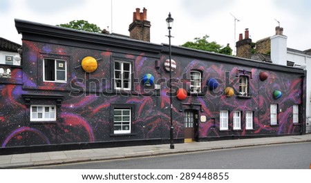LONDON - JUNE 20, 2015. Temporary painted mural with appied planets, by artist Steve Stephenson on the facade of The Chelsea Arts Club in the Royal Borough of Kensington and Chelsea, London.