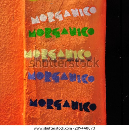 LONDON - JUNE 6, 2015. The artist Morganico signs his name on a temporary painted mural on the Old Church Street facade of the Chelsea Arts Club in the Royal Borough of Kensington and Chelsea, London.
