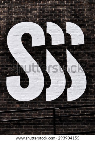 LONDON - JULY 4, 2015. Painted lettering on the brick wall of the Royal College of Art. part of their temporary logo promoting their annual show of work at Kensington Gore, London, UK.