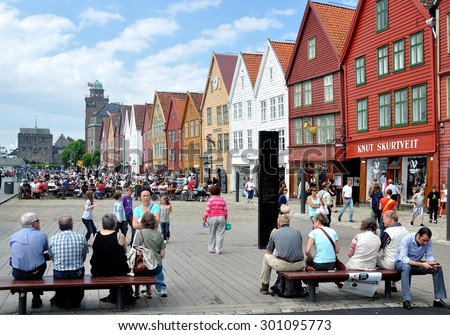 BERGEN, NORWAY - JULY 3, 2010 The Hanseatic Wharf waterfront pedestrian area, a UNESCO World Heritage Site with shops and open-air cafes and the Rosenkrantz Tower beyond in Bergen, Norway.