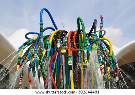 LONDON -- JULY 18, 2015. The Fountain is a playful interpretation of a water feature using garden hoses by French artist Bertrand Lavier at The Magazine restaurant in Kensington Gardens, London, UK.