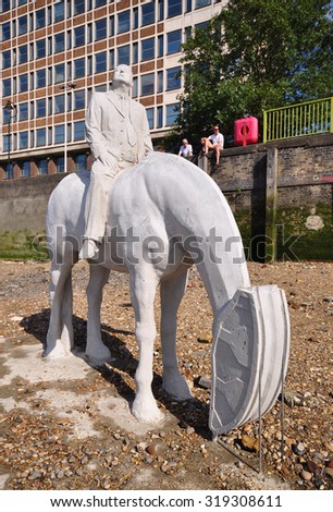LONDON - SEPTEMBER 6, 2015. A business man on a horse sculpture by Jason deClaires Taylor with an oil well pump horse head as an environmental and political warning at the river Thames, London.