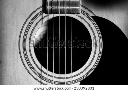 Acoustic Guitar with very shallow depth of field, focus on strings. Black & White