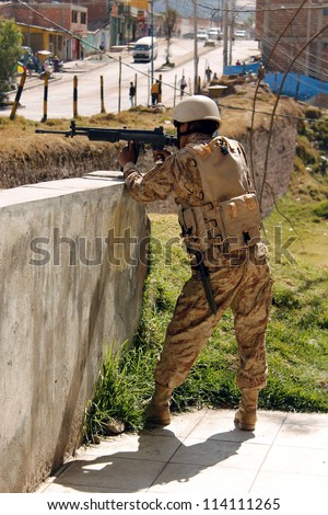 CUSCO, PERU - JULY 19: Peruvian soldier in defense position during the military exercises on July 19, 2012 in Cusco, Peru.