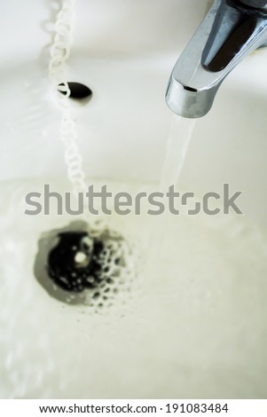 Open water tap with flowing water
