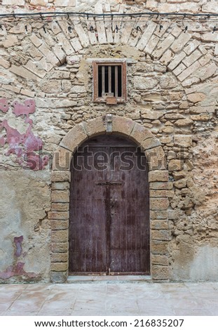 The old purple wooden door of the old building in Essaouira, Morocco