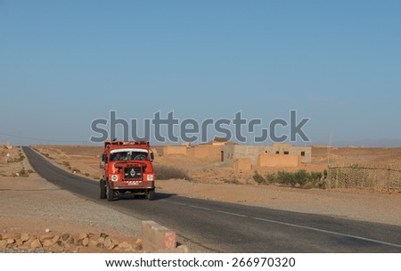 Municipalete Kelaa M\'Gouna, Morocco - Mar 16: The african drive drive red truck on the way to Fes on March 16, 2014 in Municipalete Kelaa M\'Gouna, Morocco