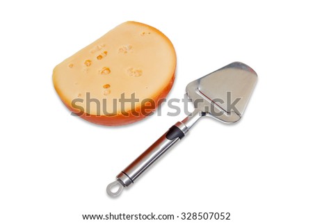 Piece of hard cheese and cheese slicer made of stainless steel on a light background. Isolation.