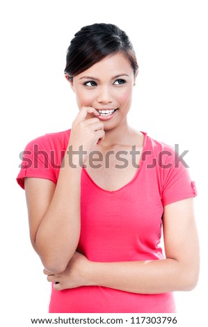 Portrait of a pretty young woman biting her finger over white background