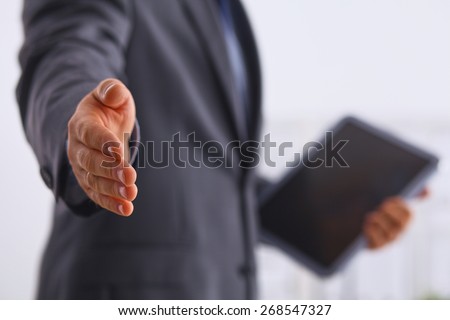 Portrait of businessman giving hand for handshake