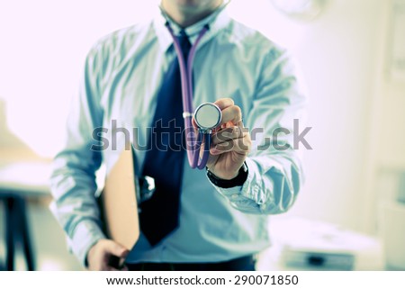 Doctor hand holding a stethoscope listening to heartbeat