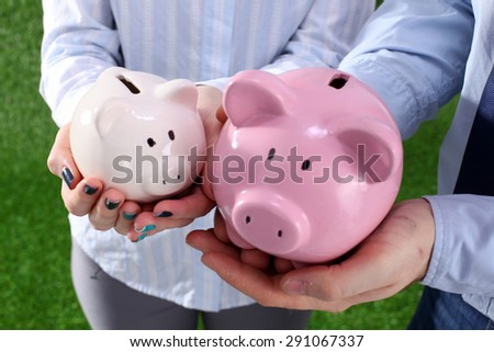 Piggy Bank in hands of a family