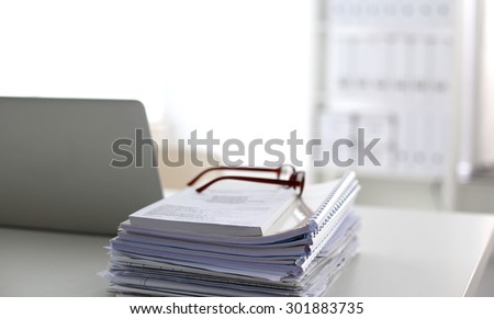 office desk a stack of computer paper reports work forms