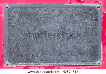Close up grunge name plate on red color rusty steel sheet